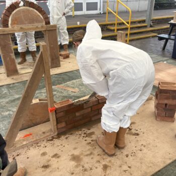 Students laying bricks