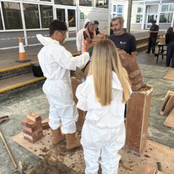 Students laying bricks
