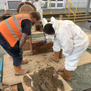 Students laying bricks